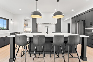 Kitchen with a large island and black chairs