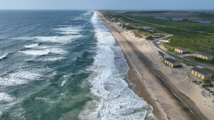 Outer Banks, NC Cape Hatteras National Seashore barrier islands waves breaking on shore with natural sand dunes popular vacation destination for outdoor lovers
