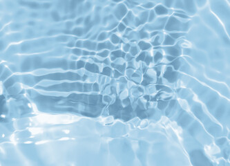 Abstract blurred shades of blue water background. Light and shadow ripples or splashes surface of water texture. Water waves with shining and reflection pattern photography for​ design artwork.