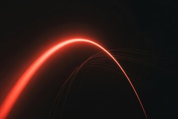 Dynamic red light trail arcs across dark background, evoking speed and energy, perfect for tech visuals