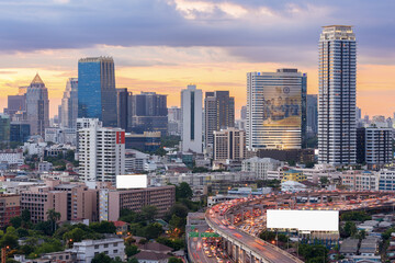 Fototapeta premium Landscape building modern business district of Bangkok with the expressway in the foreground at sunset or sunrise.