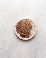 Overhead view of freshly grated Nutmeg in a marble tray