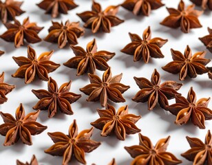 Fototapeta premium Close-up image of dried anise seeds scattered on a modern glossy white surface