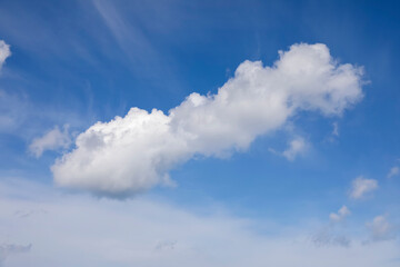 A cloud floating in a blue sky