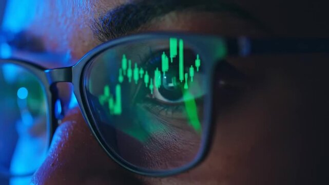 Close-up of trader's eyes reflecting stock market chart analysis and investment