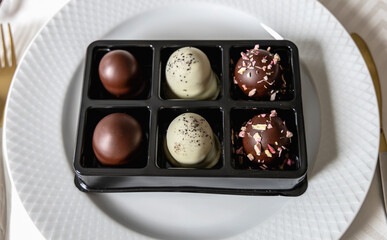 Box of chocolate marshmallow treats placed on white table plate
