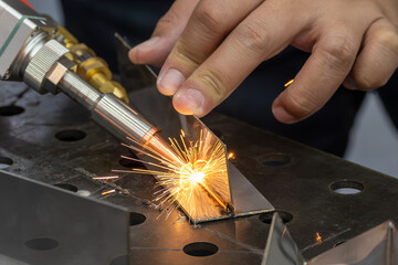 Close up scene the laser welding process by hand held laser welding machine. © Pixel_B