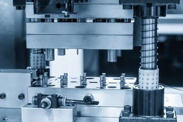 The metal parts mass production by progressive die in the light blue scene.