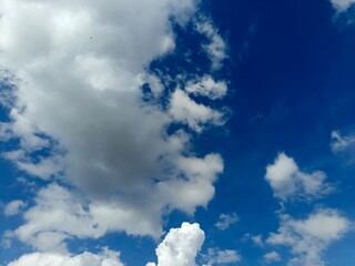 Blue sky with fluffy white clouds in daylight