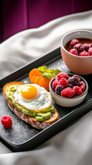 A breakfast tray is placed on white bedding, featuring a poached egg on toast, avocado slices, fresh raspberries, and a cup of hot tea, perfect for a relaxing morning at home