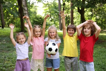 Fototapeta premium Cute little kids with soccer ball in park