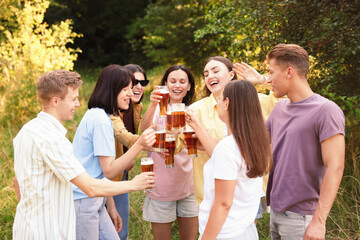 Group of happy friends clinking glasses of beer outdoors