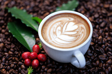 cappuccino white cup, and green coffee leaves, and red raw coffee, with roasted coffee beans backgrounds abstrack