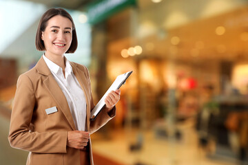 Young hostess with clipboard near boutique. Space for text