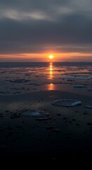 Obraz premium Warm sunset over frozen ocean landscape