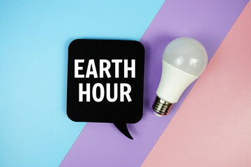 Earth Hour text on speech bubble top view on blue, purple and pink geometric background
