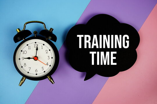 Training Time text on speech bubble with alarm clock top view on  blue, purple and pink geometric background