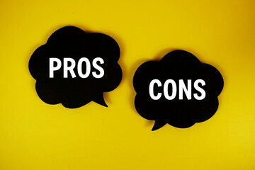 Pros And Cons text on speech bubble top view on yellow background