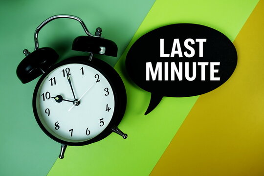Last Minute text on speech bubble with alarm clock top view on green and yellow geometric background