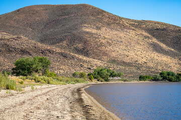 Photograph of the sandy beach of Washoe Lake Nevada in the Washoe Lake State park located between Reno and Carson City Nevada. during summertime.