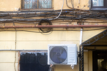 Air conditioners are installed on the facade of the building. device for comfortable living in hot...