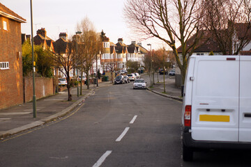 Quiet suburban street at golden hour with soft winter light