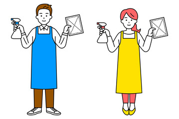 スプレー洗剤と雑巾を持つエプロン姿の男女（全身）