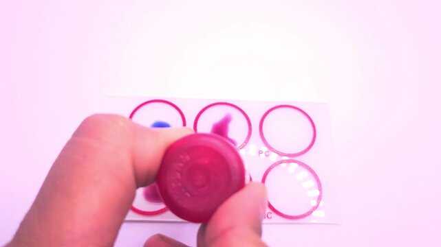 Widal test by agglutination method at plate isolated on white background, to diagnosis Typhoid and Paratyphoid fever at laboratory, Closeup microbiology research in laboratory.