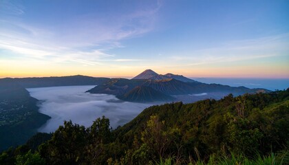 Experience breathtaking dawn over misty volcanic peaks, a truly majestic natural panorama awaits