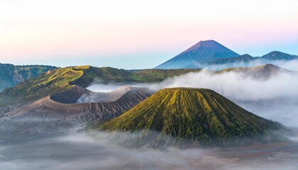 Stunning volcanic landscape at dawn with misty peaks and lush green slopes bathed in soft light © ardian