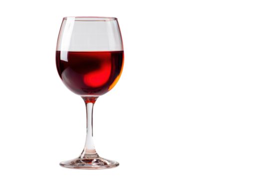 A glass of red wine is sitting on a table. The wine is almost gone, and the glass is almost empty. The wine is a deep red color, and the glass is clear. Concept of relaxation and enjoyment
