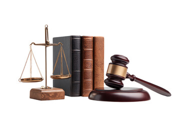 A scale, a book, and a gavel are on a table. The gavel is on top of a wooden base