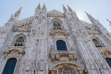 Fototapeta premium Duomo di Milano square in Milan city. Gothic Italian architecture. Italy. Sculptures and statues facade decor details