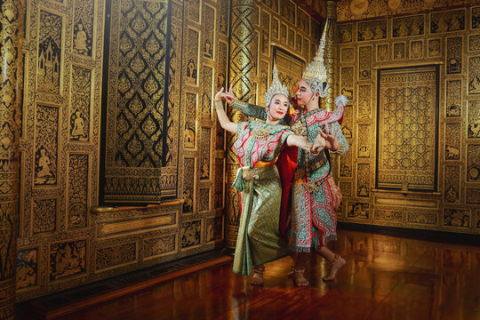 Two dancers performing a classical Thai masked Khon dance performance in a temple, Thailand