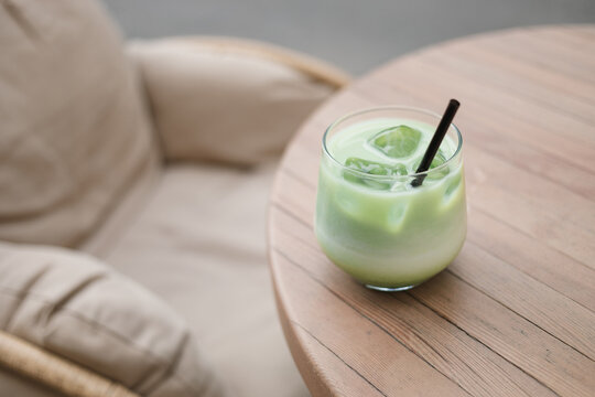 Close-up of an iced matcha latte drink on a garden table