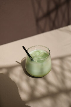 Close-up of an iced matcha latte drink on a garden table