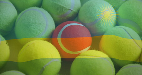 Showing yellow tennis balls with single red ball resting on flat surface, with Rwanda flag overlay