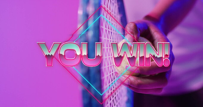 Clutching hand around yellow tennis ball against net in studio, with neon diamond, YOU WIN overlay