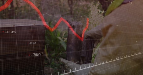 Standing senior executive in suit gazing amid foliage, with red trend line, numeric grid overlay