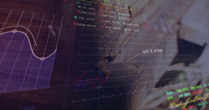 Analyzing man wearing business-casual attire reviewing digital stock charts at office, with laptop