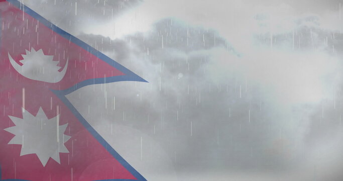 fluttering Nepal flag showing sun and moon symbols under gray sky, with falling rain, copy space - Powered by Adobe