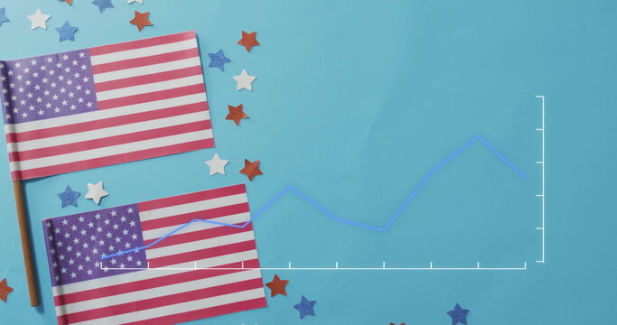 Naklejki Displaying two American flags on sticks lying on tabletop, with confetti, line chart, copy space