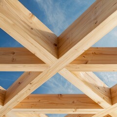 A wooden structure forms an intricate crisscross pattern against a blue sky, showcasing craftsmanship and design.