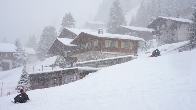 Snow winter in the mountain village in Swiss Alps brings fun to the people