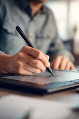 Close-up of hand drawing on tablet