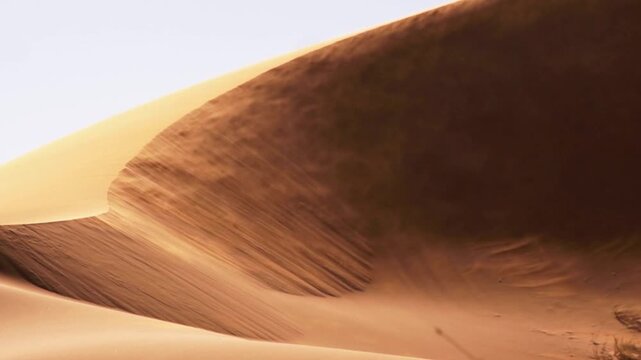 Sand dune in the desert with wind blowing sand, scenic landscape in africa