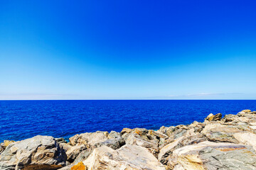 Rocky coast with blue waters of Atlantic Ocean and clear sky in sunny weather. Spain. Grand Canaia.