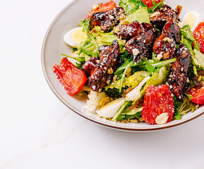 Fresh salad with grilled chicken and vegetables served in a bowl