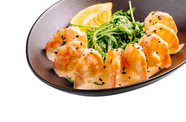 Delicious shrimp served with a creamy sauce and fresh greens on a plate
