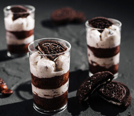 Delicious layered dessert with cookies and cream served in clear glasses
